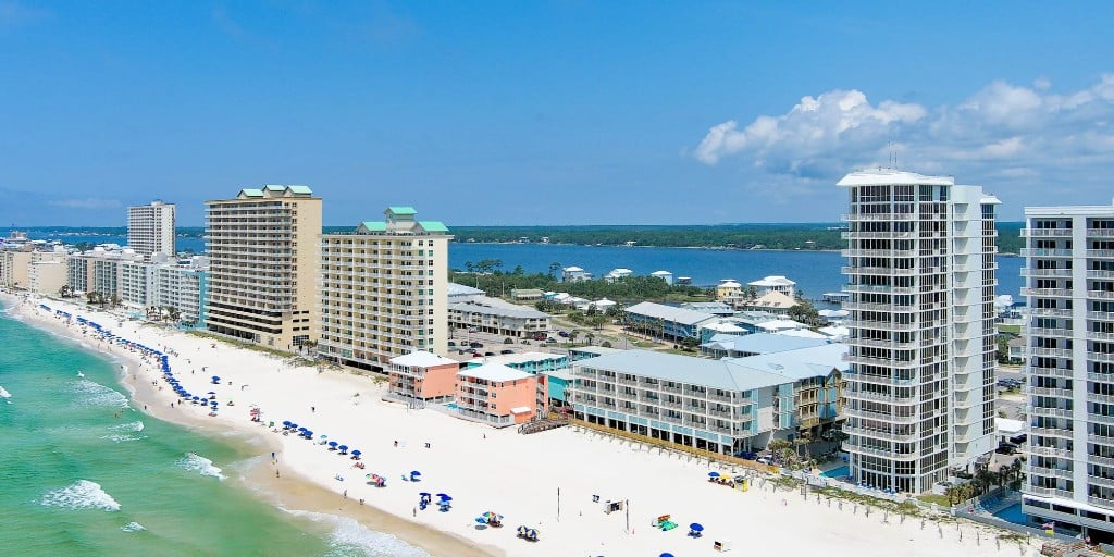 Aerial view of the Gulf Coast beach with beachfront condominiums and turquoise water